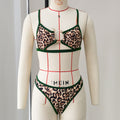 Leopard print swimsuit with green trim on a mannequin against a plain background