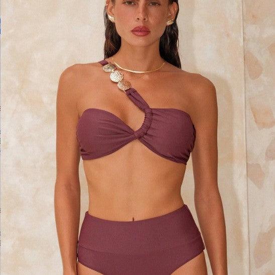 Woman wearing a purple bikini against a neutral background