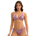 Woman wearing a purple bikini on a white background