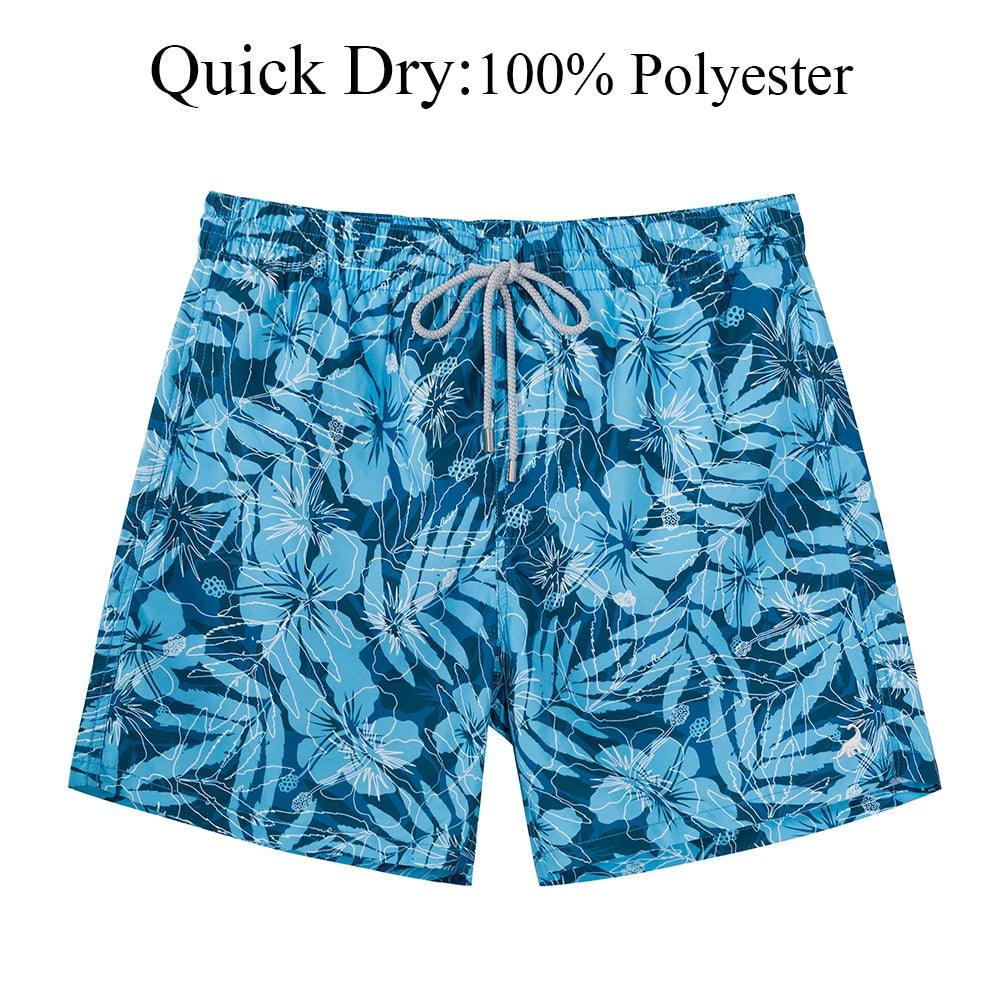 Blue floral-patterned shorts with a drawstring on a white background, labeled 'Quick Dry: 100% Polyester'.