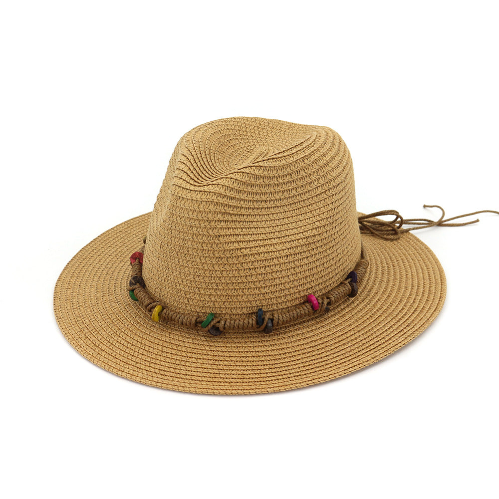 Beige straw hat with colorful tassels on a white background