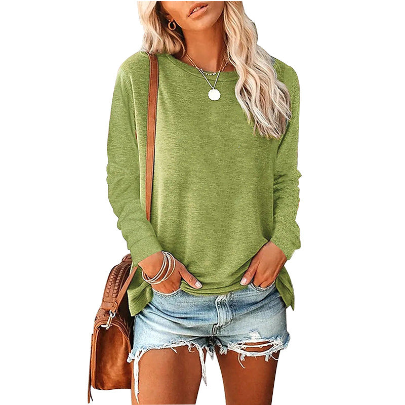Woman wearing a green sweater and denim shorts with a brown bag on a white background