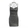 Black sparkly dress with intricate halter design on a white background