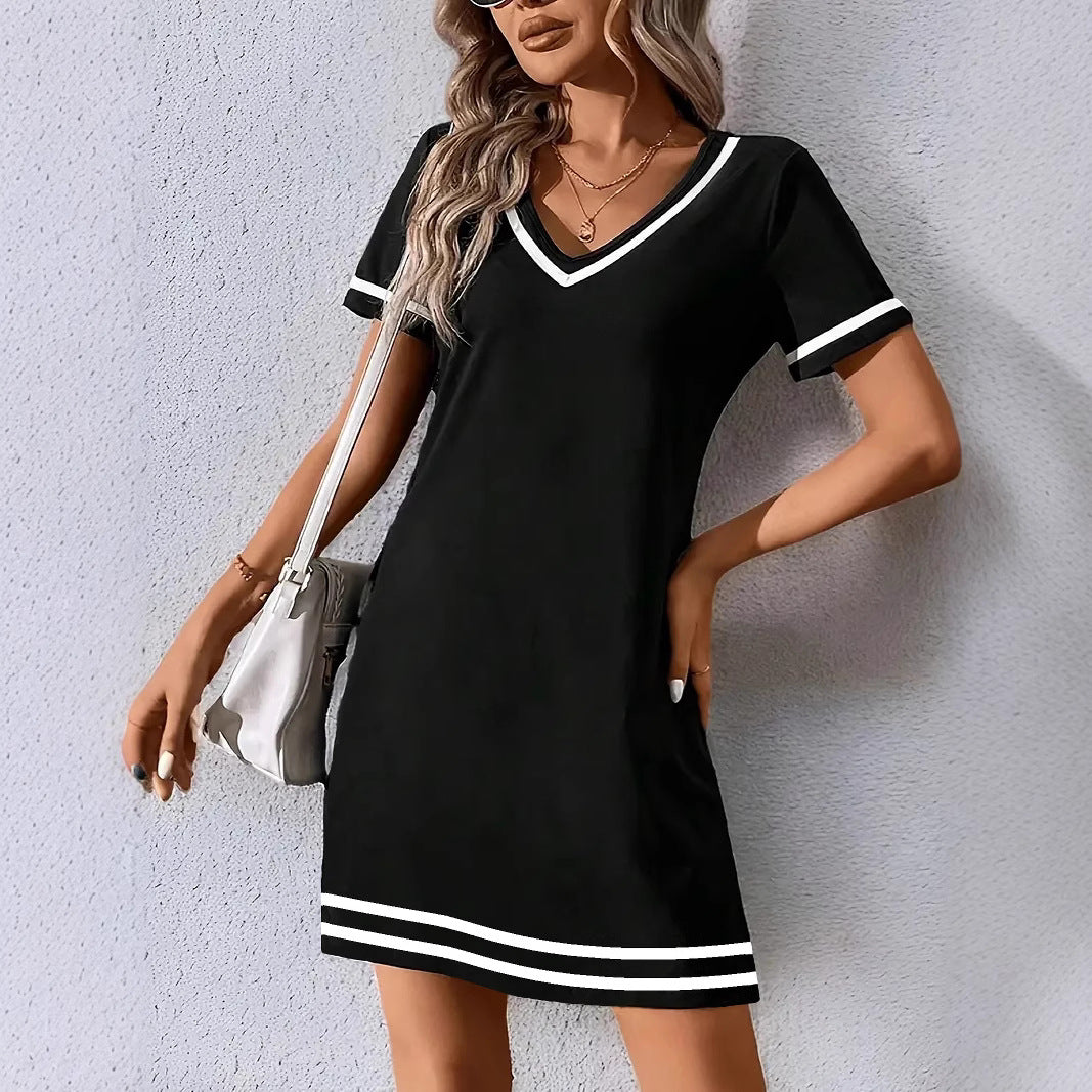Woman wearing a black dress with white trim 