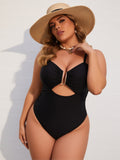 Woman wearing a black one-piece swimsuit and straw hat on a white background