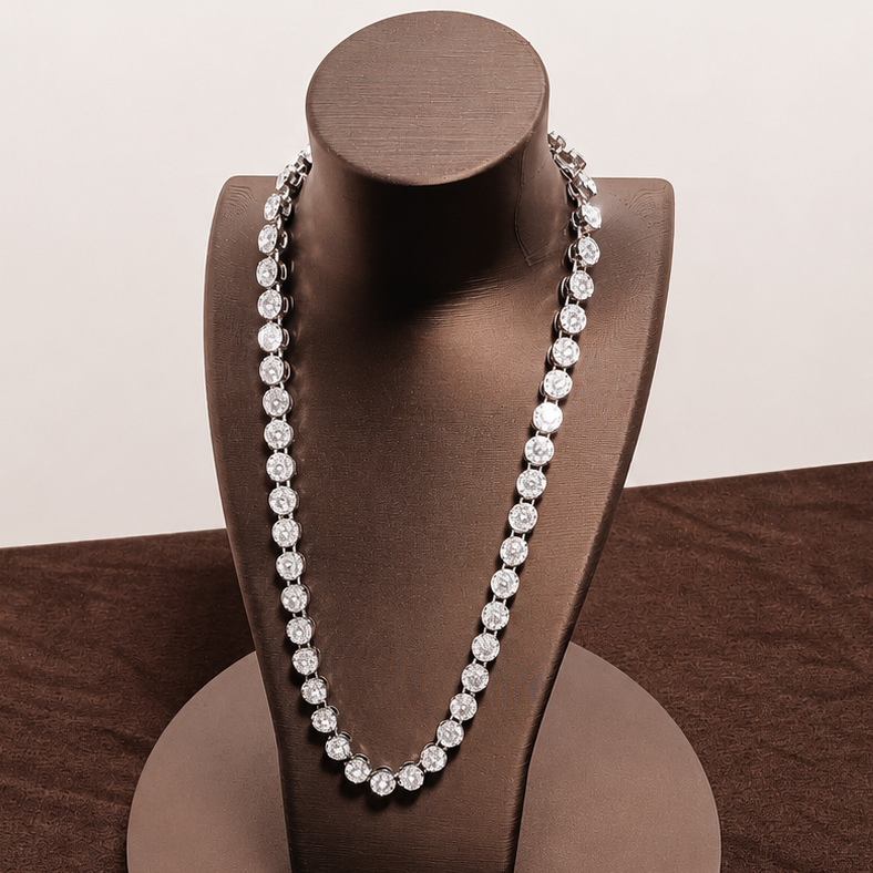 Pearl necklace on a brown jewelry stand against a brown background