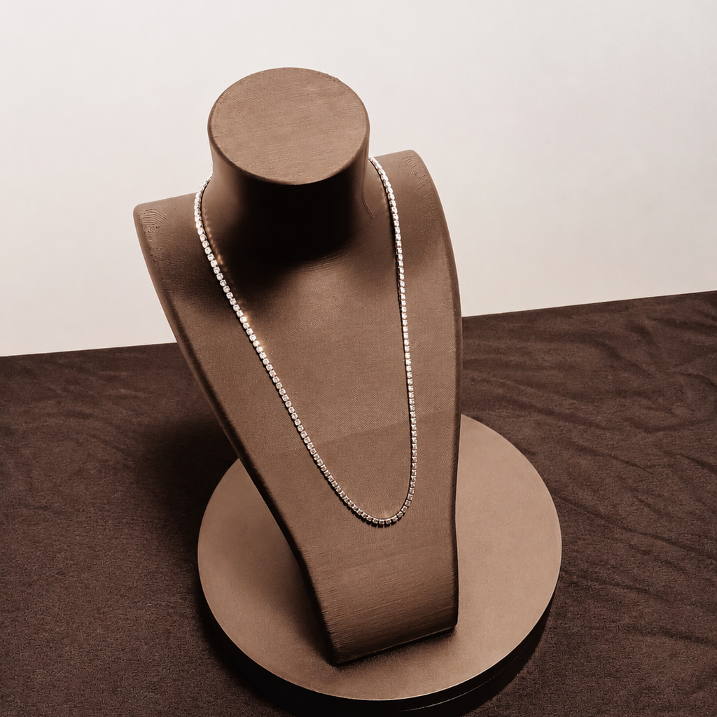 Necklace on a brown jewelry stand against a plain background
