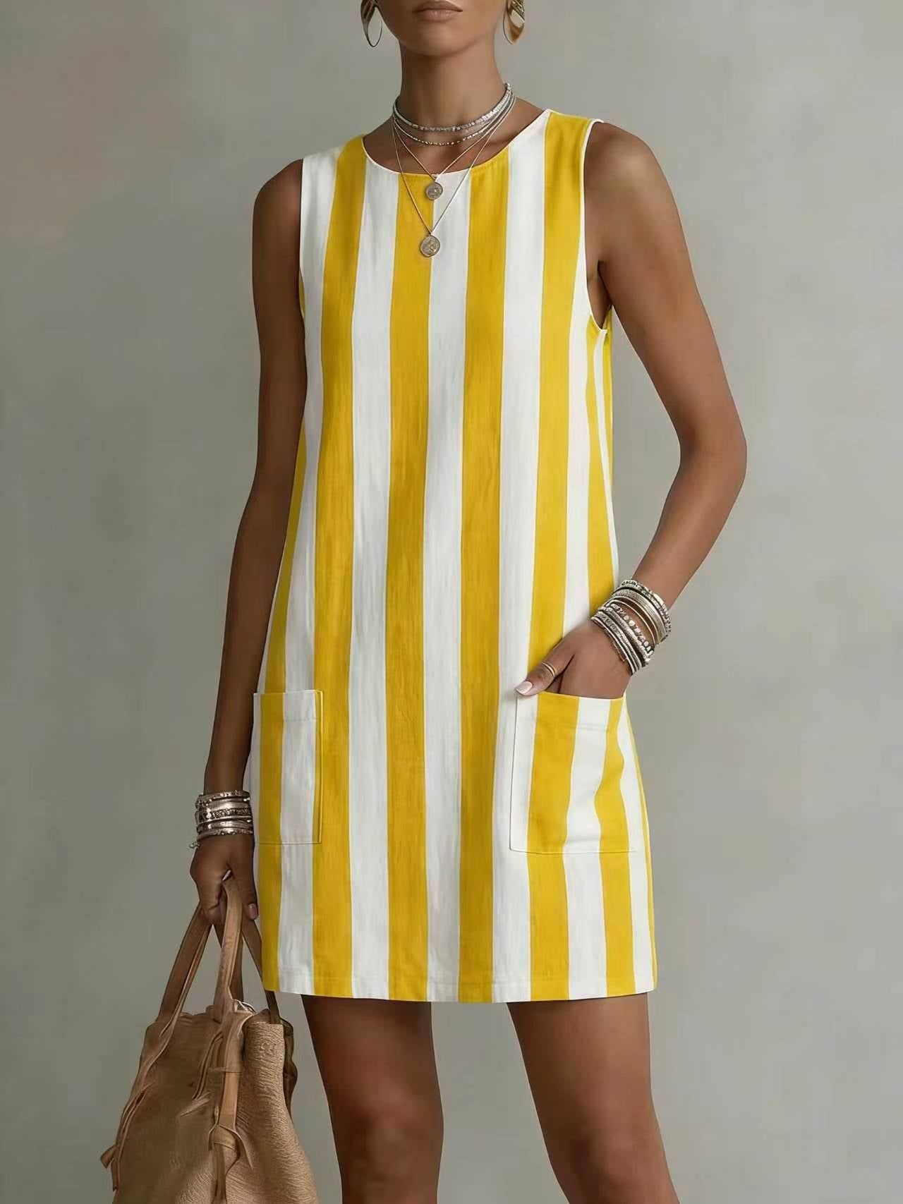 Woman wearing a yellow and white striped dress against a neutral background