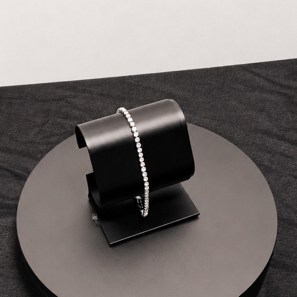 Black metal stand on a dark surface with a white background