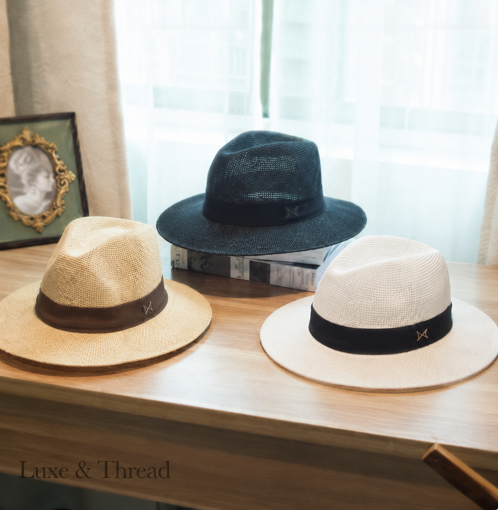 Three hats on a wooden surface with a blurred background