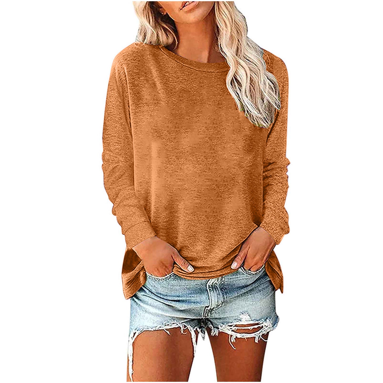 Woman wearing a brown sweater and denim shorts on a white background