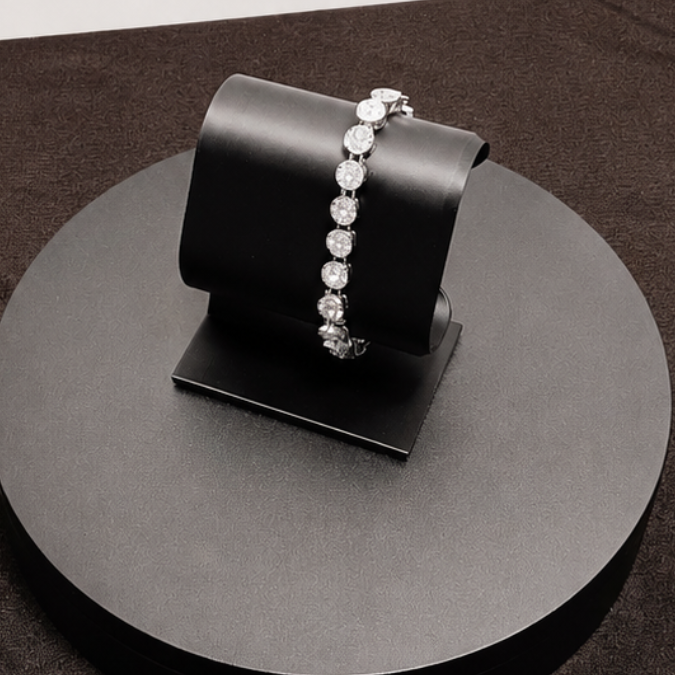 Black jewelry stand with a bracelet on a dark surface