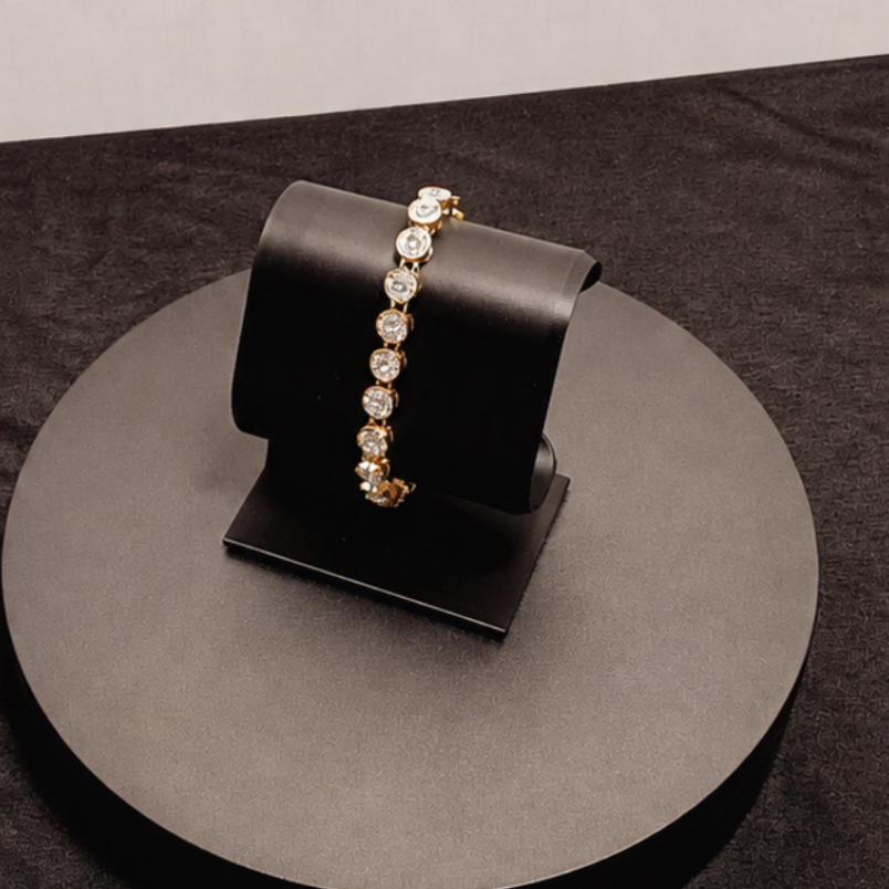 Black jewelry stand with a bracelet on a dark surface