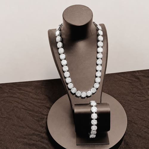 Pearl necklace on a brown stand against a dark brown background