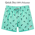 Teal swim shorts with black fish pattern on a white background