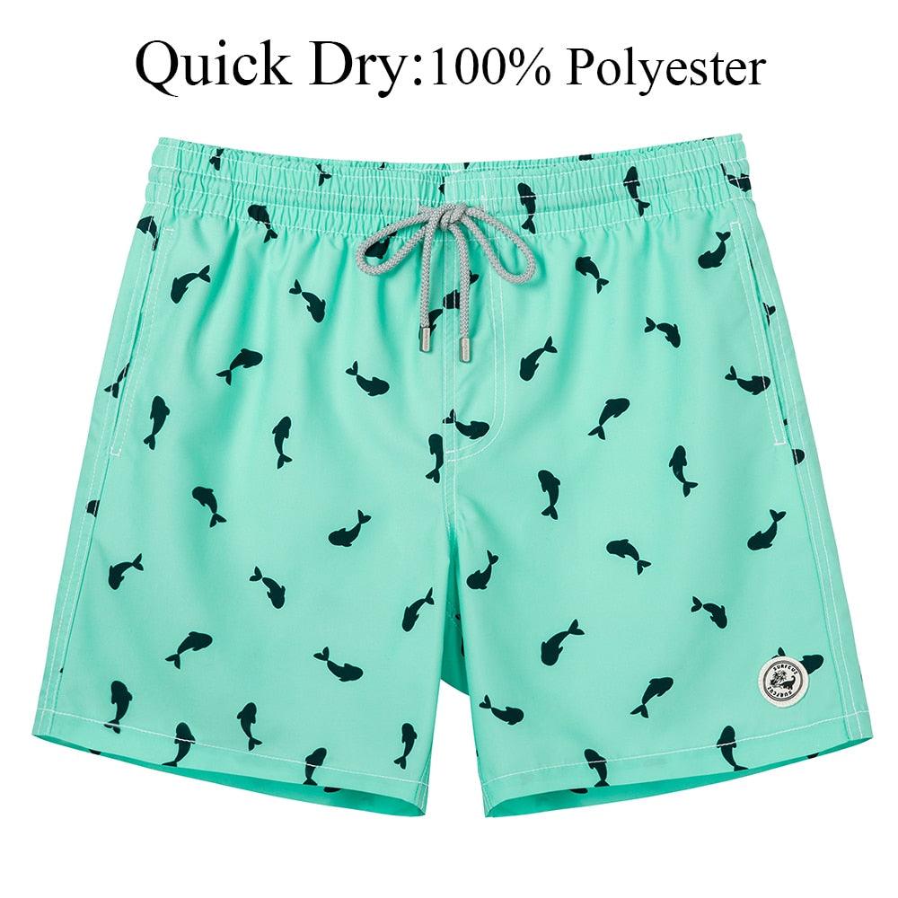 Teal swim shorts with black fish pattern on a white background
