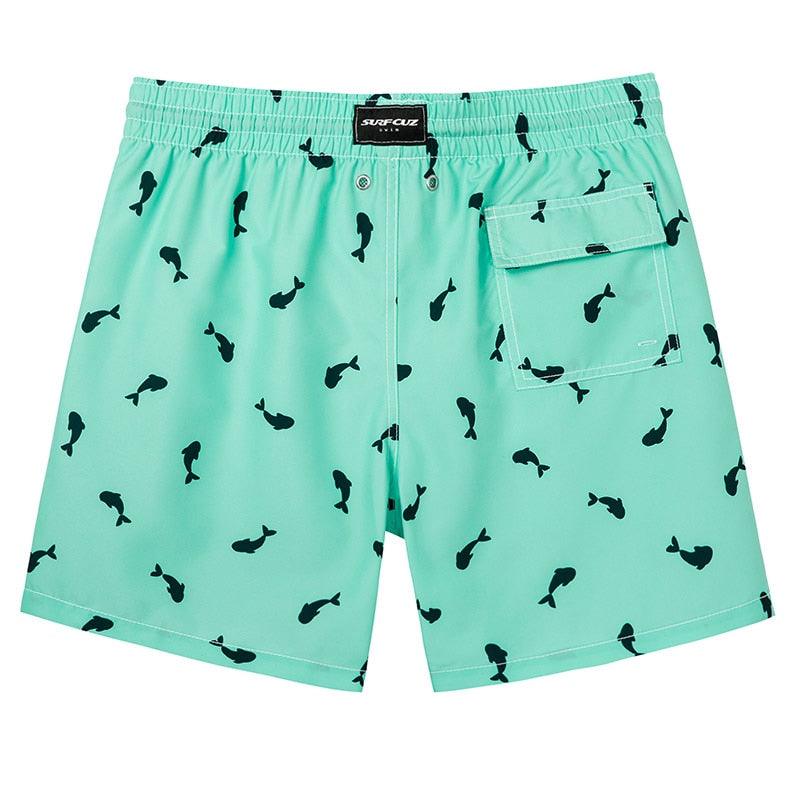 Teal shorts with black fish pattern on a white background