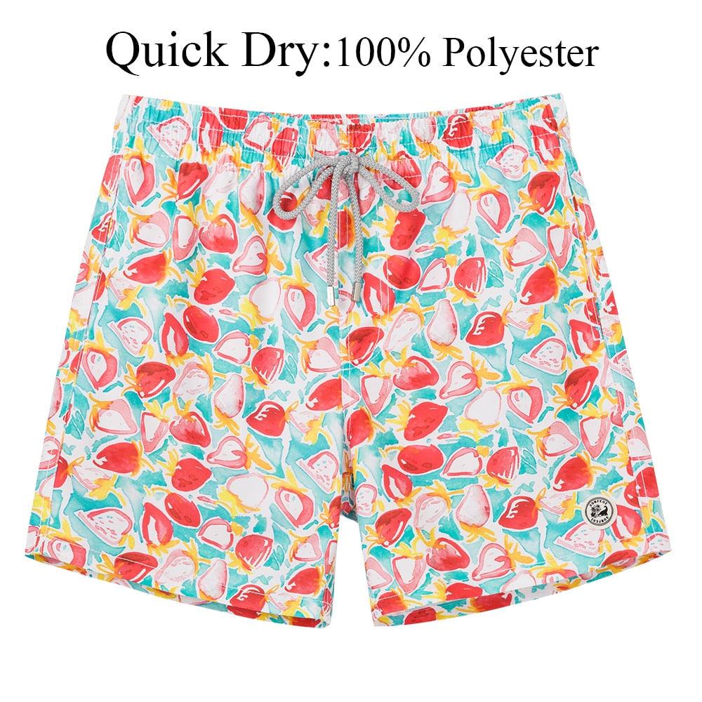 Colorful swim shorts with fruit pattern on a white background