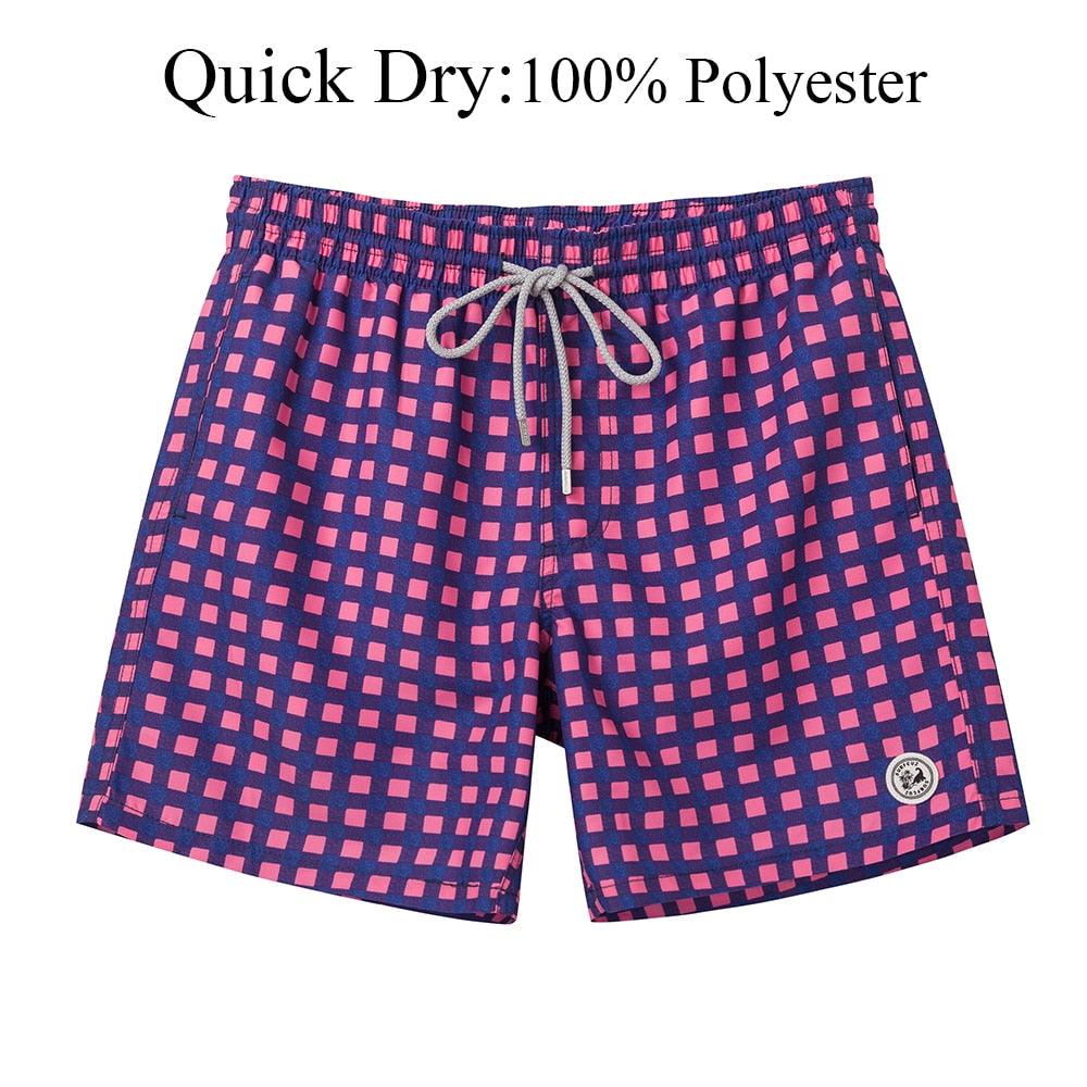 Pink and blue checkered shorts with a drawstring on a white background, labeled as quick dry 100% polyester.